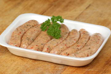 pork sausages in a white styrofoam container