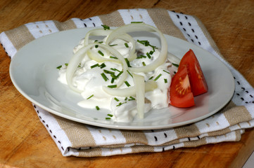 young herring in yogurt sauce on a white plate