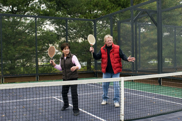 man and woman playing paddle platform tennis sport