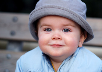 Smiling baby with a grey hat