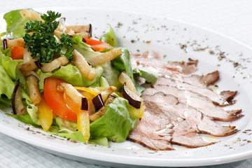 sliced beef with vegetable garnish