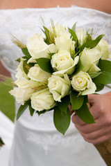 Bride holding bouquet of roses