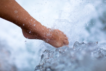 Fototapeta premium female leg under cold water