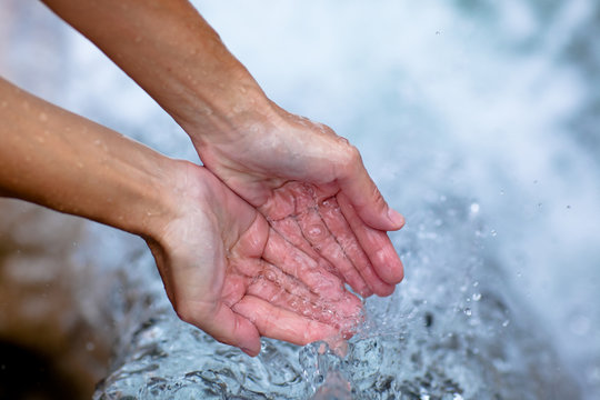 female hands and clear water