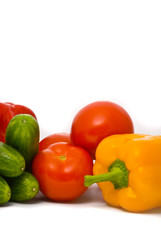 Fresh tomatoes, cucumbers and pepper on a studio white backgroun