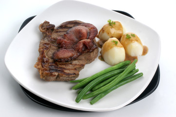 grilled rump steak and bacon with potato and sauce