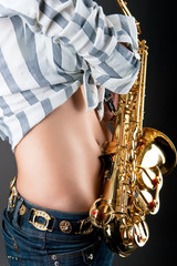 sexy stomach of young blonde girl with saxophone isolated