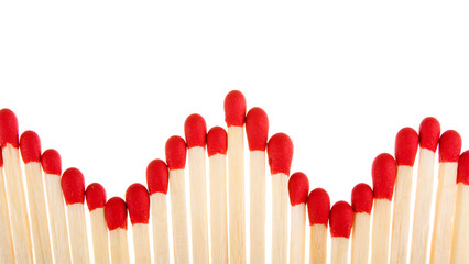 Set of red matches close up on white background