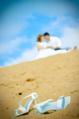 bride shoes and newly married couple