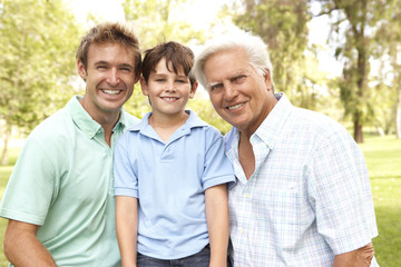 Obraz premium Grandfather With Father And Son In Park
