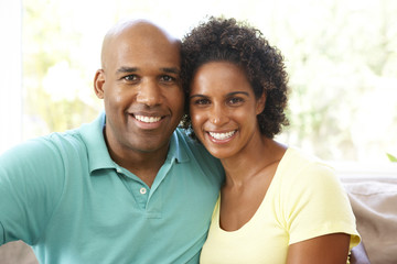 Young Couple Relaxing On Sofa At Home