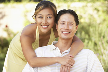 Obraz premium Young Couple Hugging In Garden