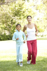 Fototapeta premium Mother And Daughter Exercising In Park
