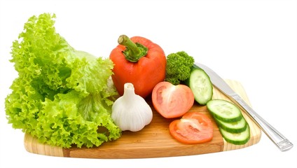 Salad and vegetables on a chopping board isolated on white