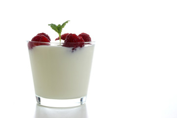 some organic raspberries in natural yoghurt and mint