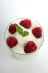 some organic raspberries in natural yoghurt and mint