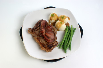 grilled rump steak and bacon with organic vegetable