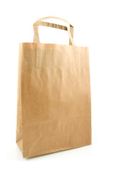 Empty paper shopping bag over white background
