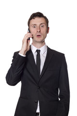 surprised businessman with a mobile