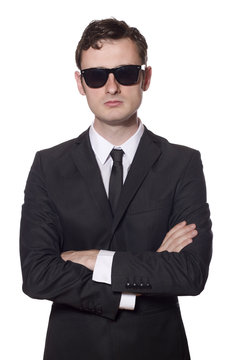 bodyguard with glasses and folded arms