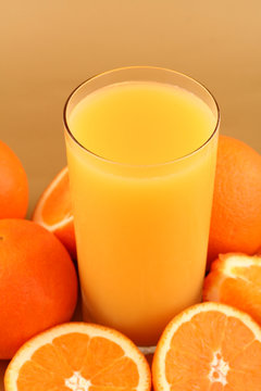 Orange juice on oranges background