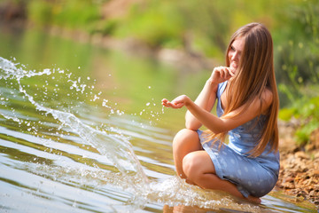 Young woman playing with water