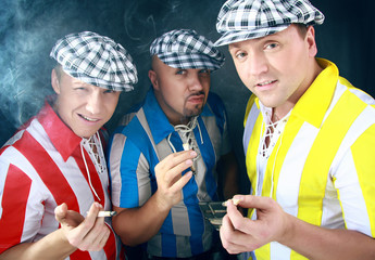 Football fans in bright T-shorts and striped caps.