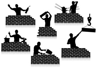 Workers silhouettes close-up and construction wall