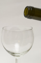 Bottle's neck and empty wine glass