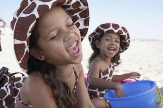 Young mixed race girls playing at beach