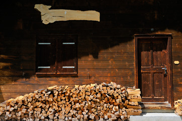 firewood laying in the front of a house