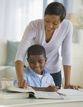 African mother helping son with homework