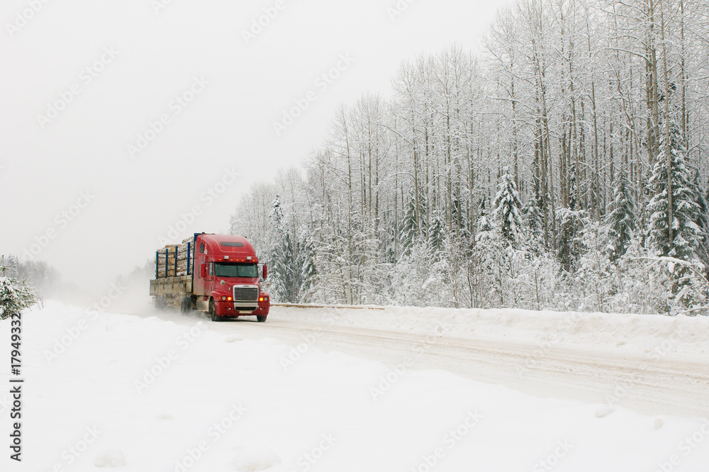 Wall mural red truck on winter road