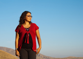 Beautiful asian woman at the sunset in the mountains