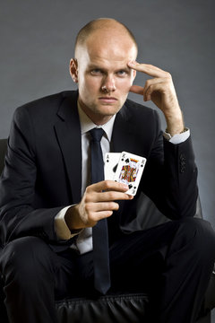 businessman holding a poker hand - A K