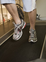 Fototapeta na wymiar Man running on a treadmill