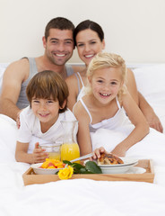 Obraz na płótnie Canvas Family having breakfast in bedroom