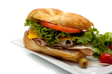 A turkey sandwich on a croissant