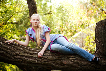 Pretty young girl on a tree
