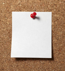 notes with push pins on cork board office business