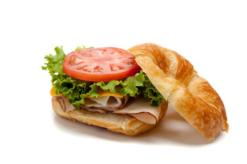 A turkey sandwich on a croissant