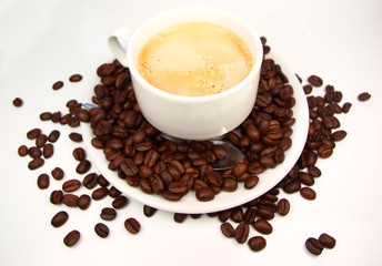 Cup of coffee with coffee beans isolated on white