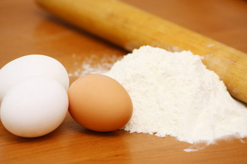 Fototapeta na wymiar eggs, flour and rolling pin