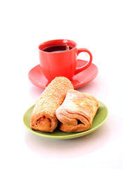 Buns and cup of tea on white