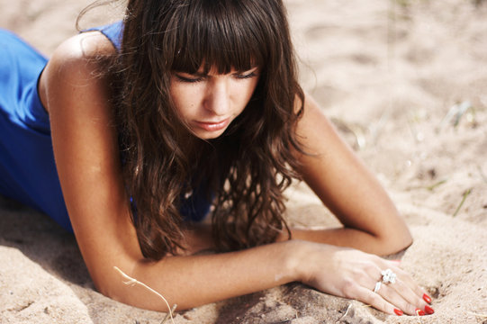 girl lies on sand