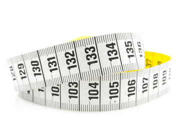 White measure tape in closeup over white background
