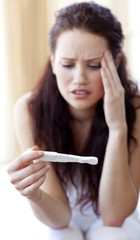 Woman looking at a pregnancy test