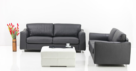 A modern minimalist living-room with white furniture