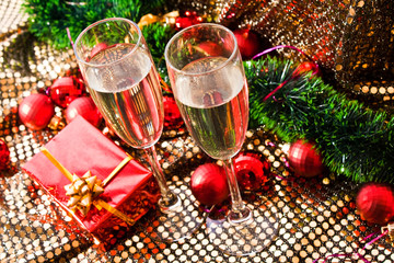 Two glasses with champagne and New Year decorations