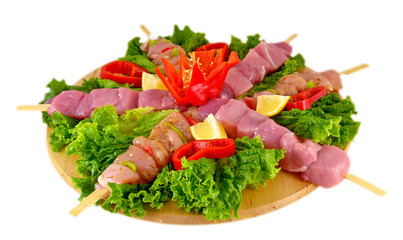 Preparing fresh beef steak shishkabobs with vegetables